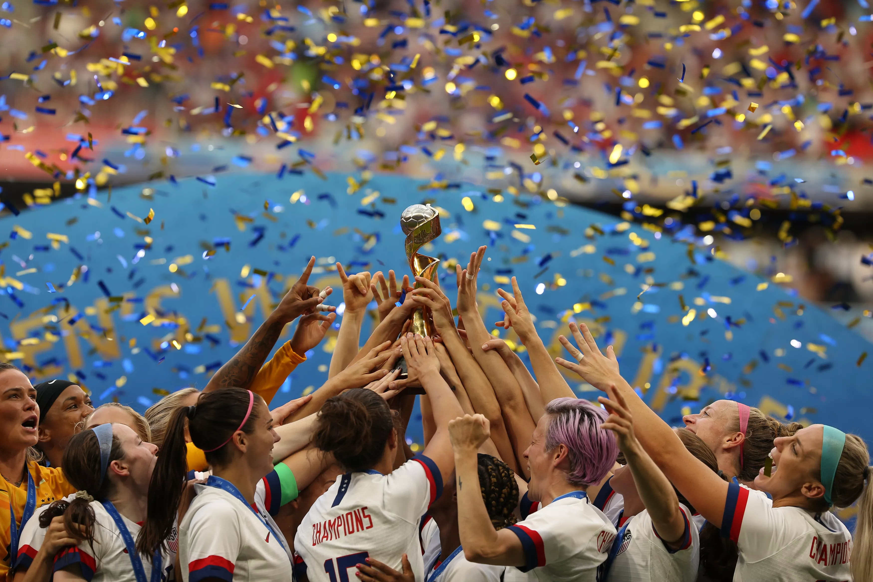Team celebration with trophy and confetti