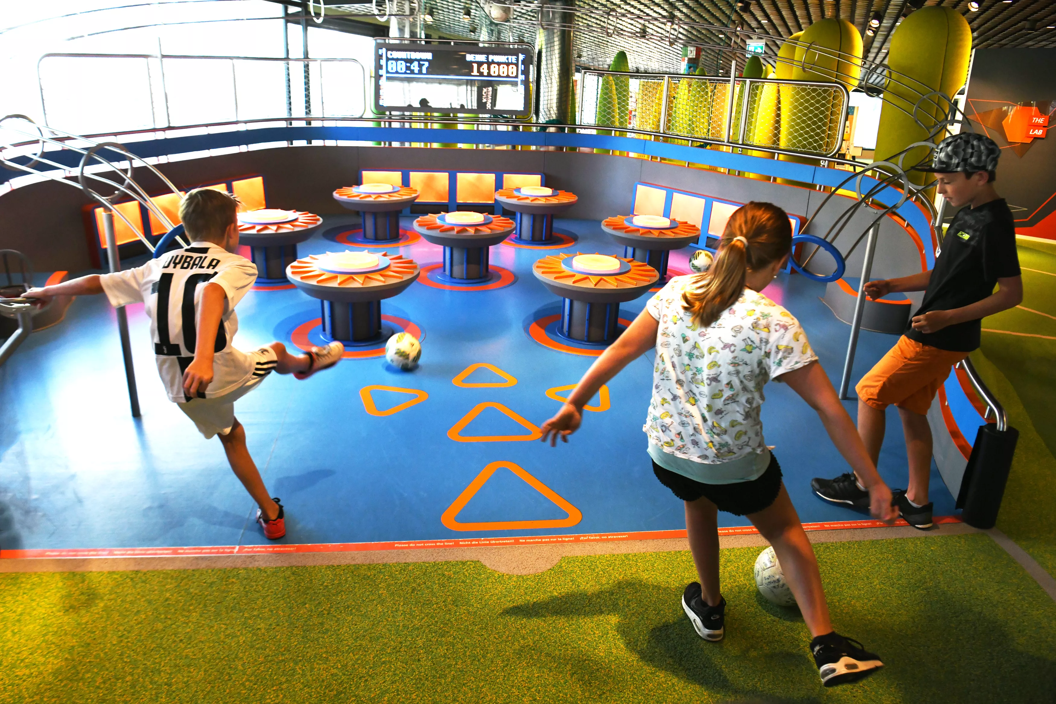 Children playing in interactive football training area